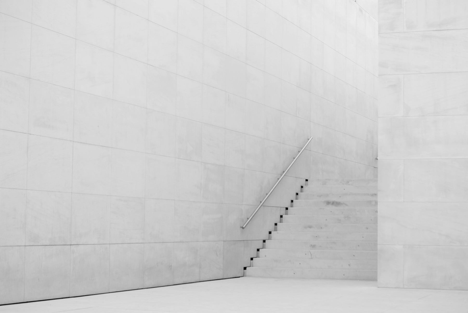 Minimalist stairs inside a structured concrete interior